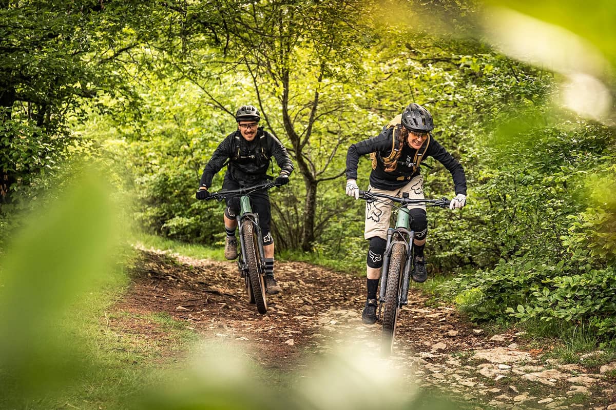 Man and woman on mountain bikes in the forest