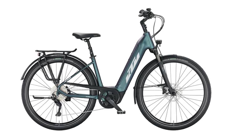 Electric touring bike with mid-drive motor, front suspension, matte green-purple frame, and rear cargo rack.