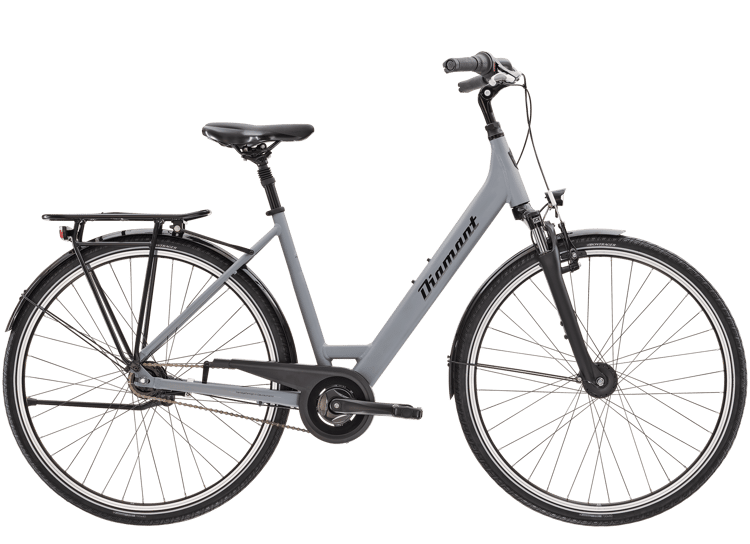 Turquoise Diamant city bike with black chain guard and rear rack, kickstand, bell, and dynamo-powered lights.