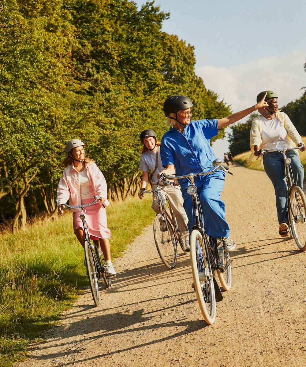Women drive over gravel road laughing
