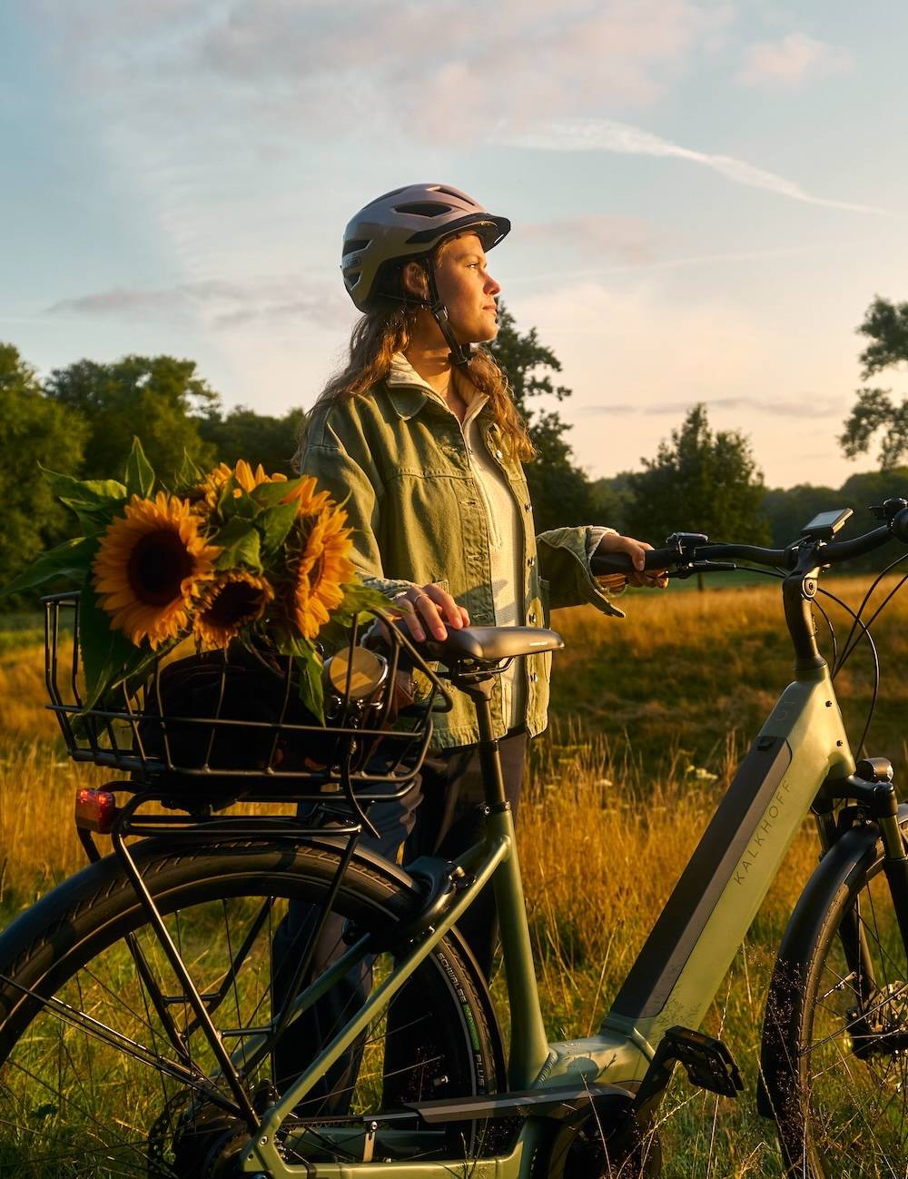 Bicycle helmet and sunflowers in the bicycle basket