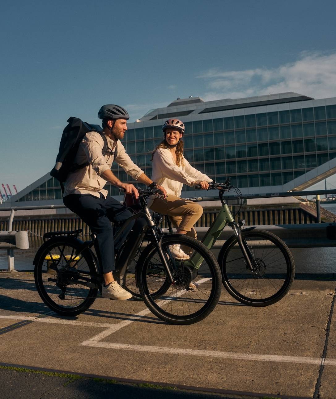 two people on bikes in front of harbour