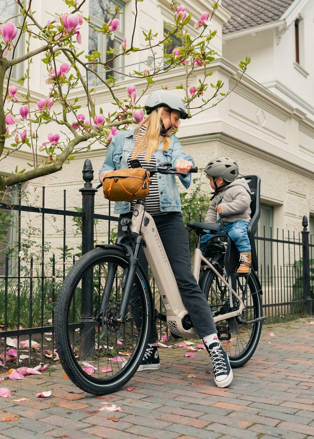 Young woman with child on e-bike