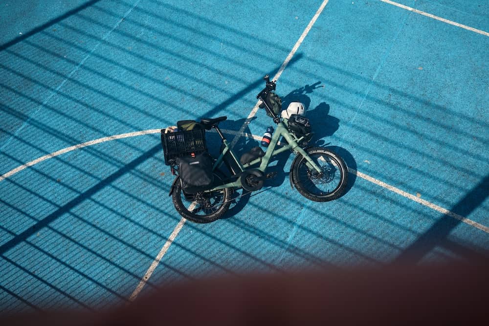 Folding e-bike lying on sports field