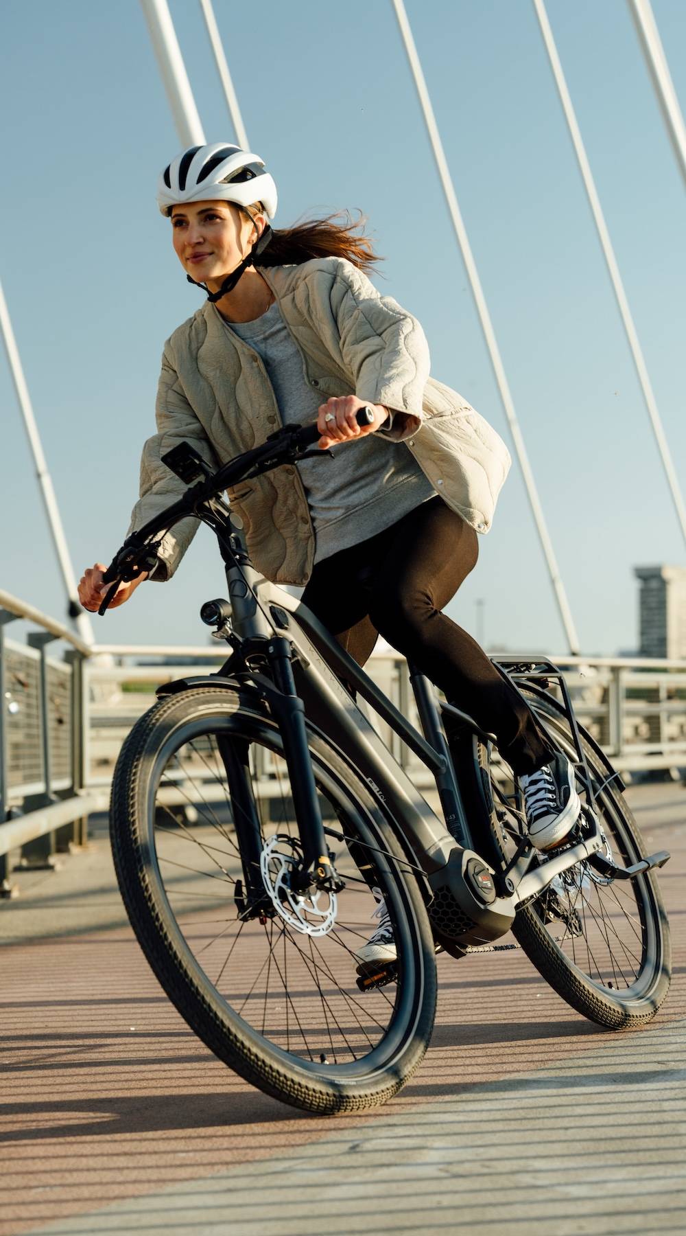 Woman riding an e-bike in an urban environment